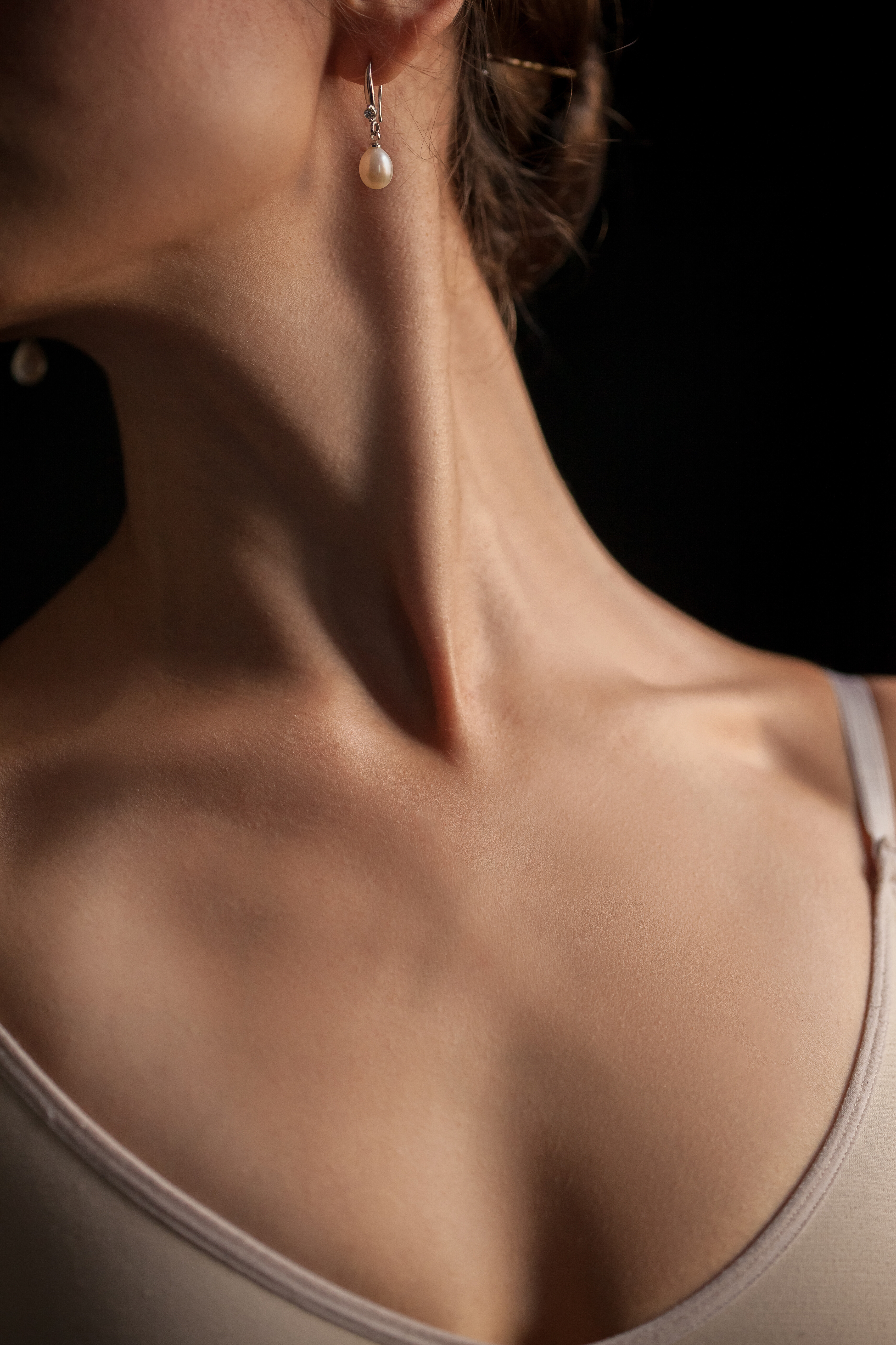 close up young woman s neck dark background 2905f